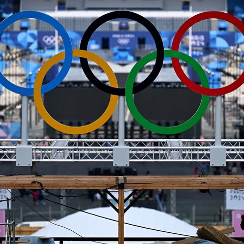 The Olympic rings are seen during preparation works at the Eiffel Tower stadium in Paris on July 24, 2024, ahead of the Paris 2024 Olympic Games.